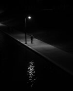 Lone Figure Under Streetlight